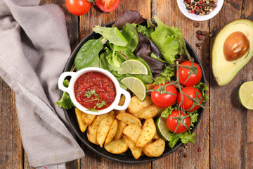 fried potato, tomato sauce and vegetable salad