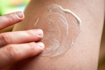 Fototapeta premium Hand applying the cream on skin.