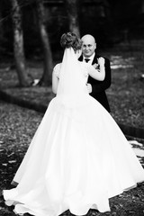 bride and groom.  Stunning sensual outdoor photo of young stylish fashion couple posing in autumn. Tenderness in every move. 