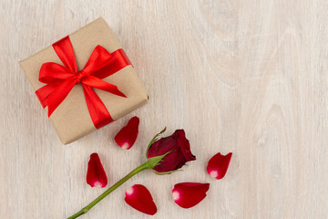 Valentine's Day Concept Gift box and red rose on the wooden table