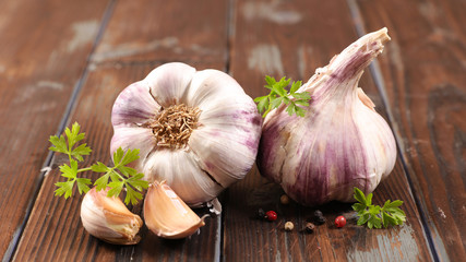 garlic clove and bulb on wood background