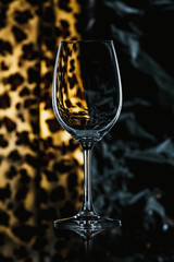 Glass wine glass stands on glass on combined background