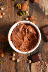 delicious vegan creamy chocolate mousse on wood background