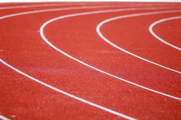 Foto op Canvas Rode running sport track achtergrond en textuur. Sport atletiekbaan concept. © Golden House Images