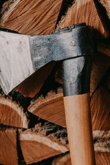 Sharp ax on background of chopped firewood