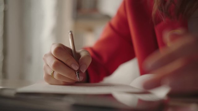 Written practices: a stylish girl writes in a notebook plans and goals