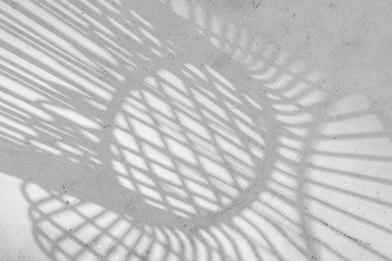 abstract backgrounds shadow of steel rod outdoor-chairs lay beautifully & looks dimension over light gray concrete flooring under beneath the warm sunlight of day
