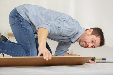 laminate flooring man in sneakers repair