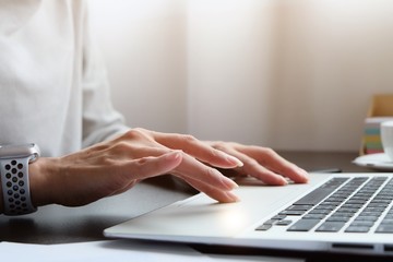 Asian woman is typing on keyboard of laptop or computer notebook for check electronic mail, preparation of presentation in meeting, get information for shopping online or operation of internet banking