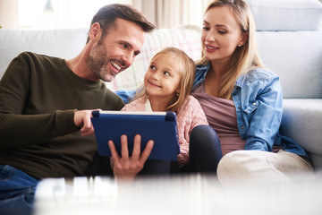 Parents and daughter using tablet