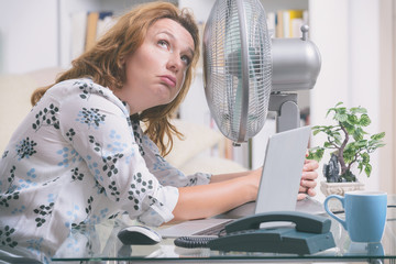 Woman suffers from heat in the office or at home