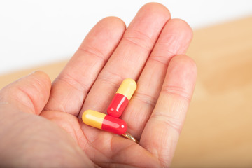Medicine : capsules in the hand of a man