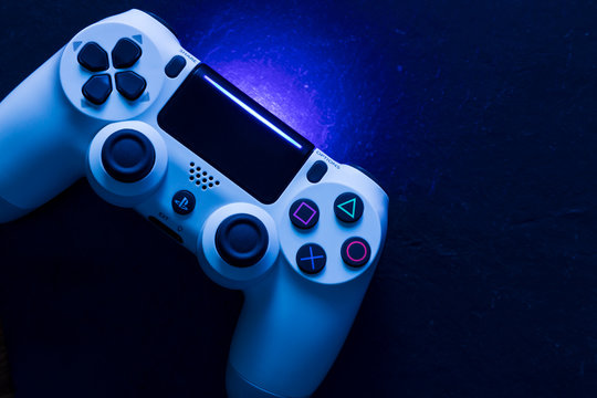 LONDON - DECEMBER 12, 2019: Video game gaming controller night with lights dark background top view