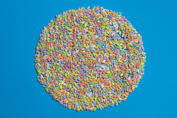  sunflower seeds in colored glaze lie on a blue background
