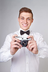 Fototapeta premium young man holding a camera