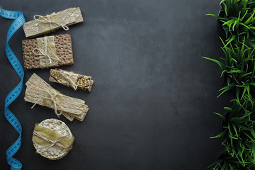 Proper nutrition. Healthy lifestyle.Dry bread rolls diet.Concept of losing weight and a healthy lifestyle. Bread roll with vegetables and herbs on table.
