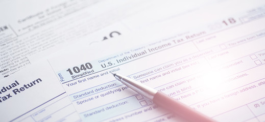 Obraz premium Annual tax reporting. Tax form on the table. Financial statements for signature.