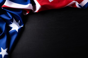 Australia day concept. Australian flag with the text Happy Australia day against a blackboard background. 26 January.