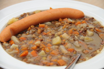 delicious freshly made lentil soup with a sausage