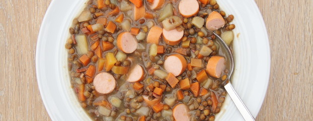 delicious freshly made lentil soup with a sausage