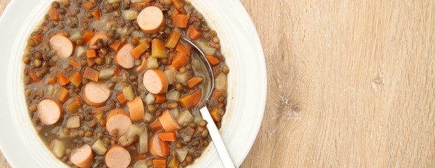 delicious freshly made lentil soup with a sausage