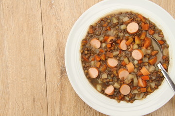 delicious freshly made lentil soup with a sausage