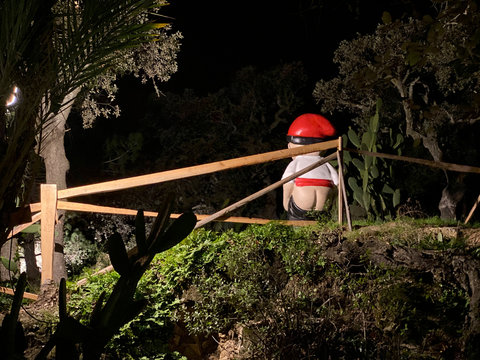 Traditional Catalan caganer figurine in forest, Christmas culture concept