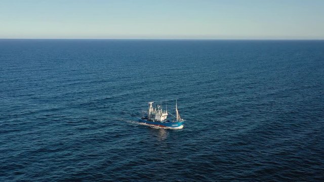 Aerial view of a fishing boat sailing in the Atlantic Ocean