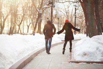 Young couple walking through the winter