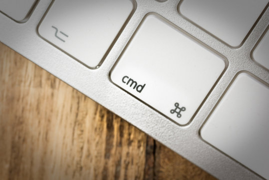 Computer keyboard - silver keyboard of a laptop with button CMD isolated. Home office with portable modern technology, IT and computing.