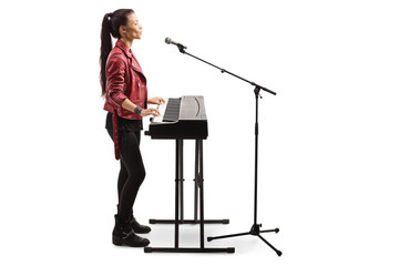 Young female artist playing a digital piano
