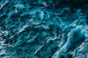 Aerial view to ocean waves. Blue water background. Dramatic colors photo.