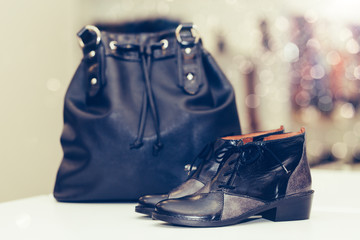 Fashionable Women Leather Shoes with a bag in the background in a store.
