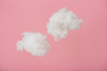 white fluffy clouds made of cotton wool isolated on pink