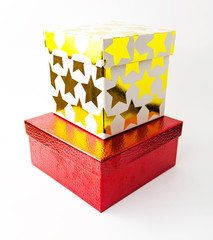 Red and white color golden starred gift paper box on white background. Holyday present concept.