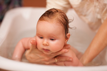 An instructor in infant swimming teaches the baby to swim. The concept of a toddlers ' swimming