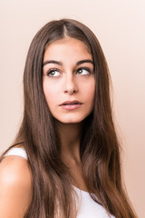 Fototapeta premium Young cute caucasian woman against a beige background