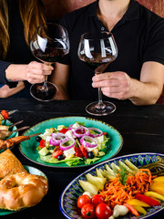 Two woman toasting with glasses of white wine, closeup