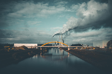 Cityscape with Thermal Power Plant Chimney and dark Clouds