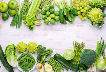Healthy eating vegan concept. Green vegetables on white table broccoli sprouts peas avocado courgette beans bok choy celery, top view, copy space, selective focus