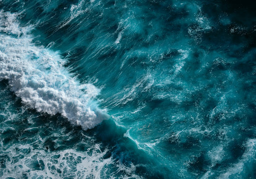 Aerial view to seething waves with foam. Blue water background. Dramatic colors photo. © Dmitry Yakovtsev