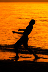 Fototapeta na wymiar silhouette of a man on the beach