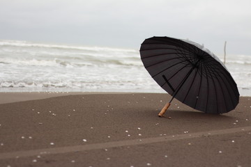 an umbrella in beach /sand