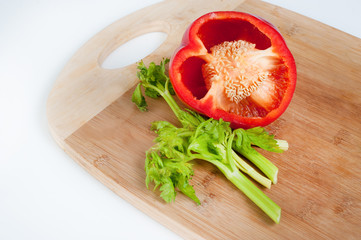 fresh carrots, onions, red pepper, celery, parsley on a mat, sliced