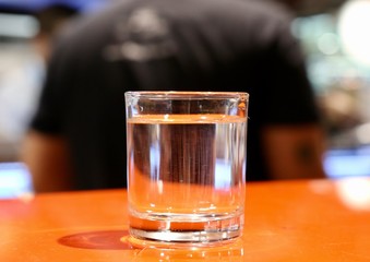 glass of whiskey on wooden table