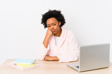 Middle aged african american woman working at home isolated who feels sad and pensive, looking at copy space.