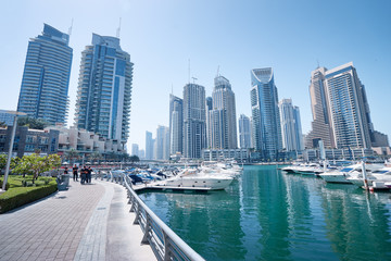 Fototapeta na wymiar Sunny day cityscape of Dubai marina embankment with skyscraper.