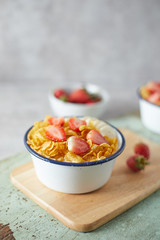 Bowl with cornflakes on background..