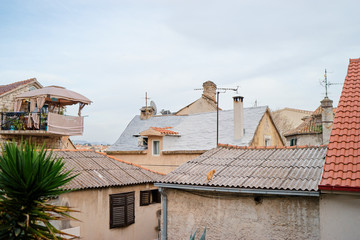 Tiled roof of old europian town with a cat on it.. Split, Croatia.