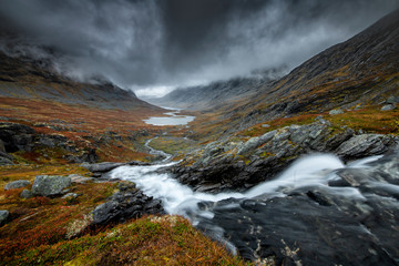 Dark landscape of Norway mountains covered with heavy clouds